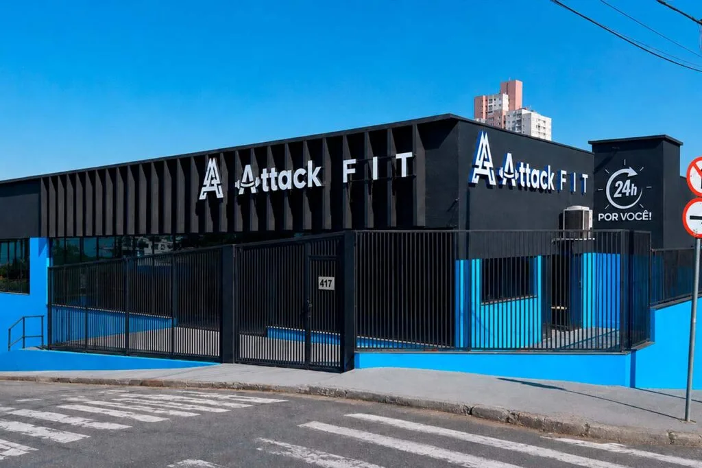 Fachada preta da Attack Fit com o selo 24h por você